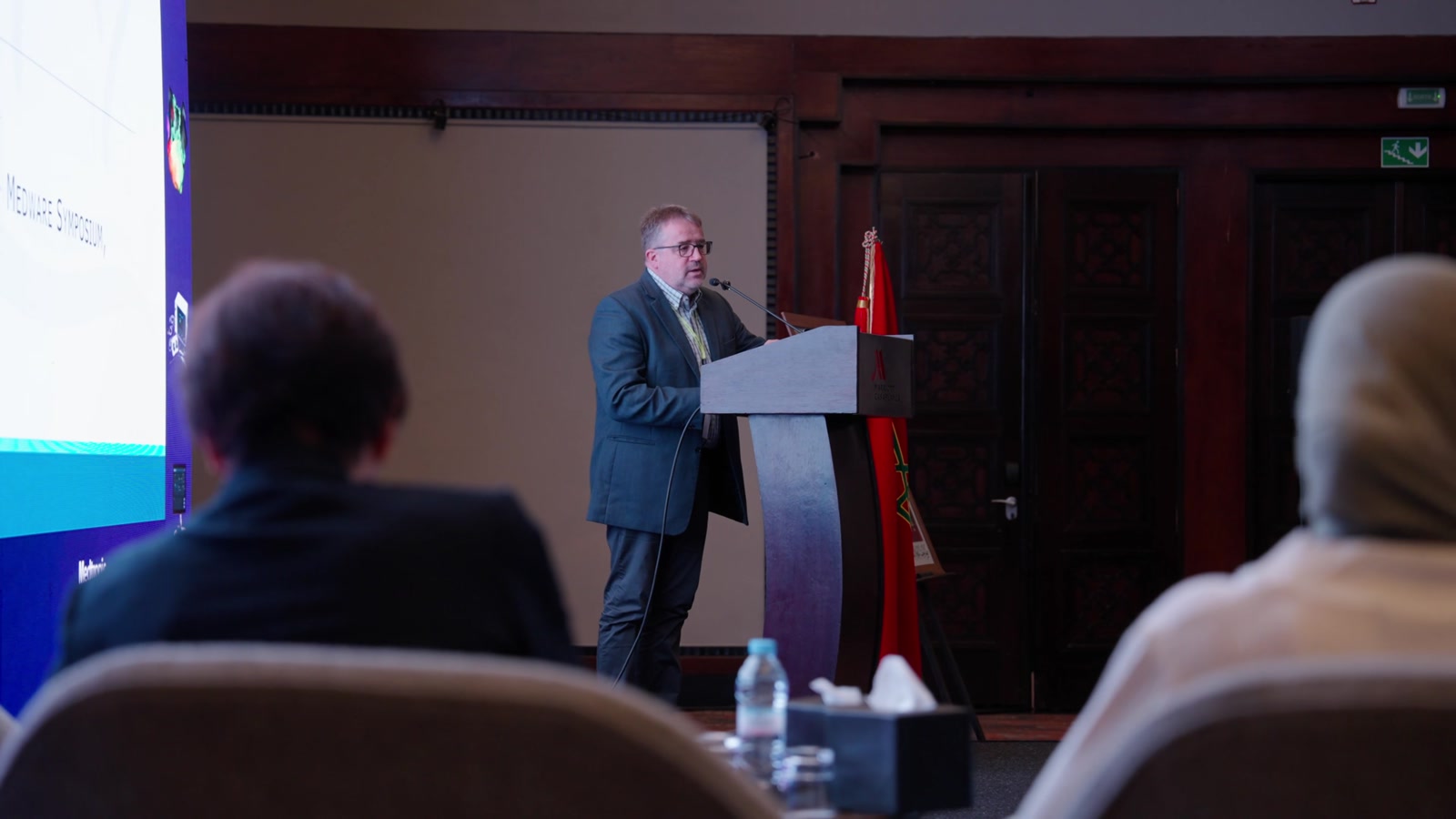 A speaker presenting at a professional event